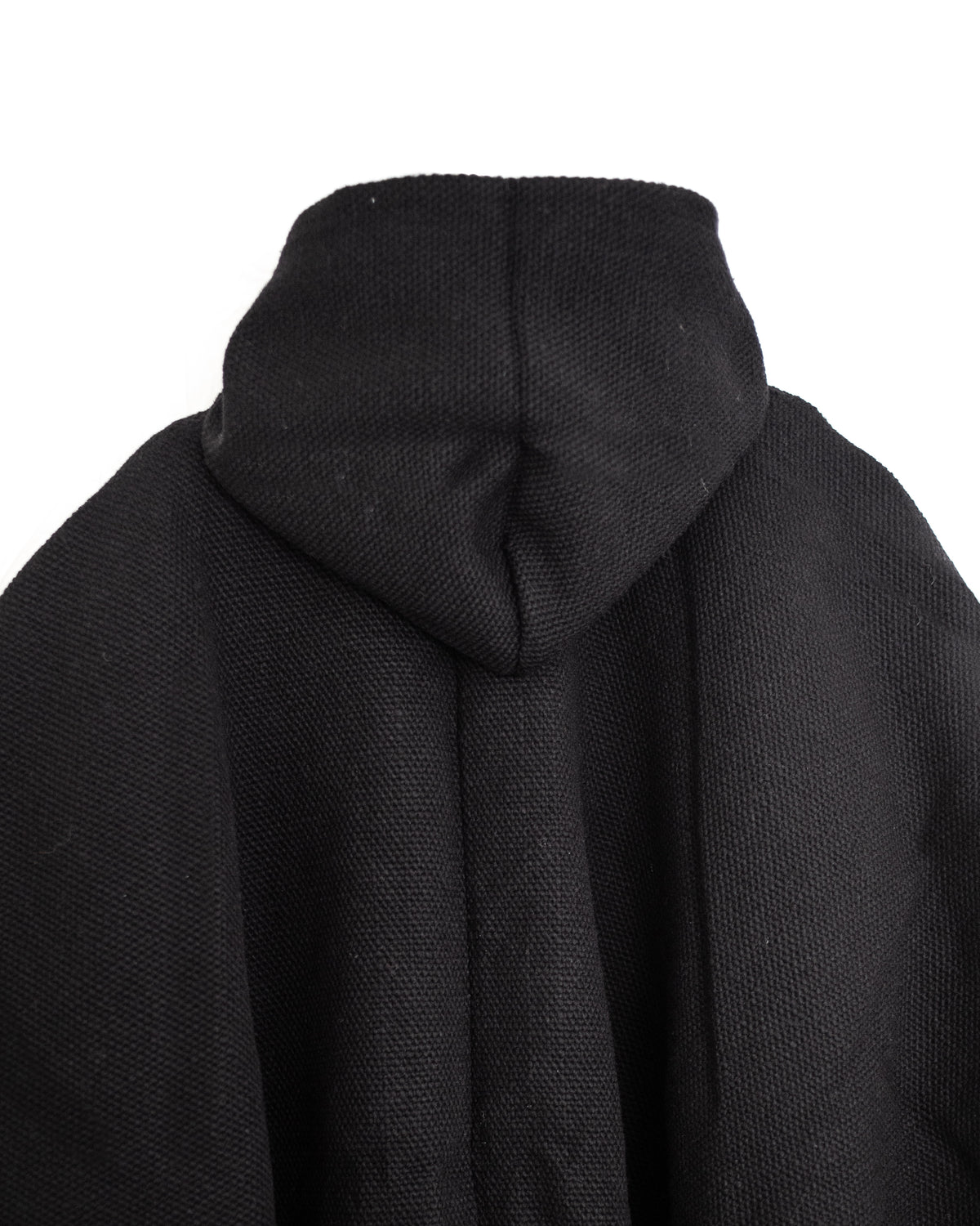 Vista trasera de detalle de gorro de poncho de lana negro artesanal